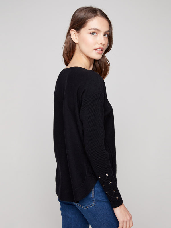 Sophisticated black knit sweater showcasing long ribbed sleeves and cuff lace-up accents for added flair by Charlie B.