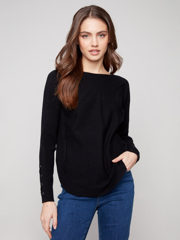 Versatile black knit sweater with rounded hem and practical side pockets, ideal for any casual outing by Charlie B.