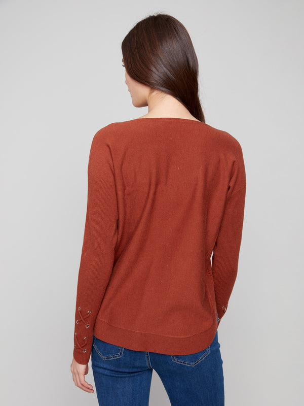 Elegant sepia knit sweater showcasing unique cuff lace-up details by Charlie B.