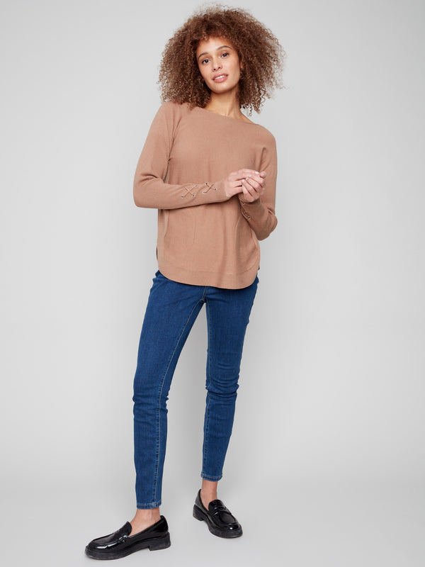 Elegant knit sweater with practical side pockets, adding functionality to fashion by Charlie B.