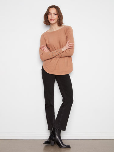 This stylish top features a rounded hem and side pockets for added functionality by Charlie B.