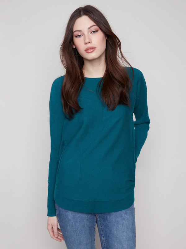 Stylish knit sweater featuring a classic boat neck design, perfect for effortless elegance by Charlie B.