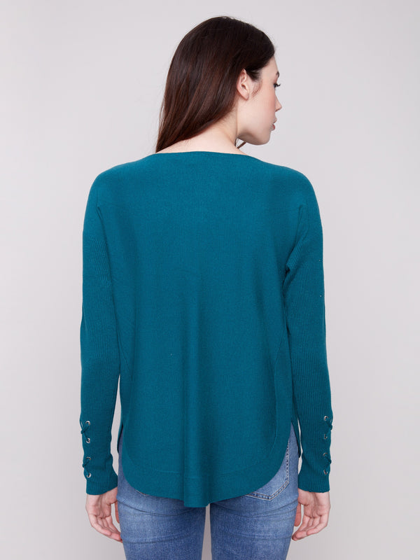 Chic knit sweater highlighted by its practical side pockets, blending style and functionality by Charlie B.