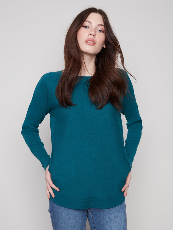 Fashionable evergreen sweater with a unique rounded hem for a modern silhouette by Charlie B.
