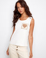 Ecru knit tank top featuring a sleeveless design and crochet heart pocket detail by Charlie B.