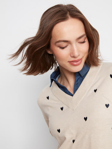 Chic drop shoulder design complements the embroidered heart accents on this elegant piece by Charlie B.
