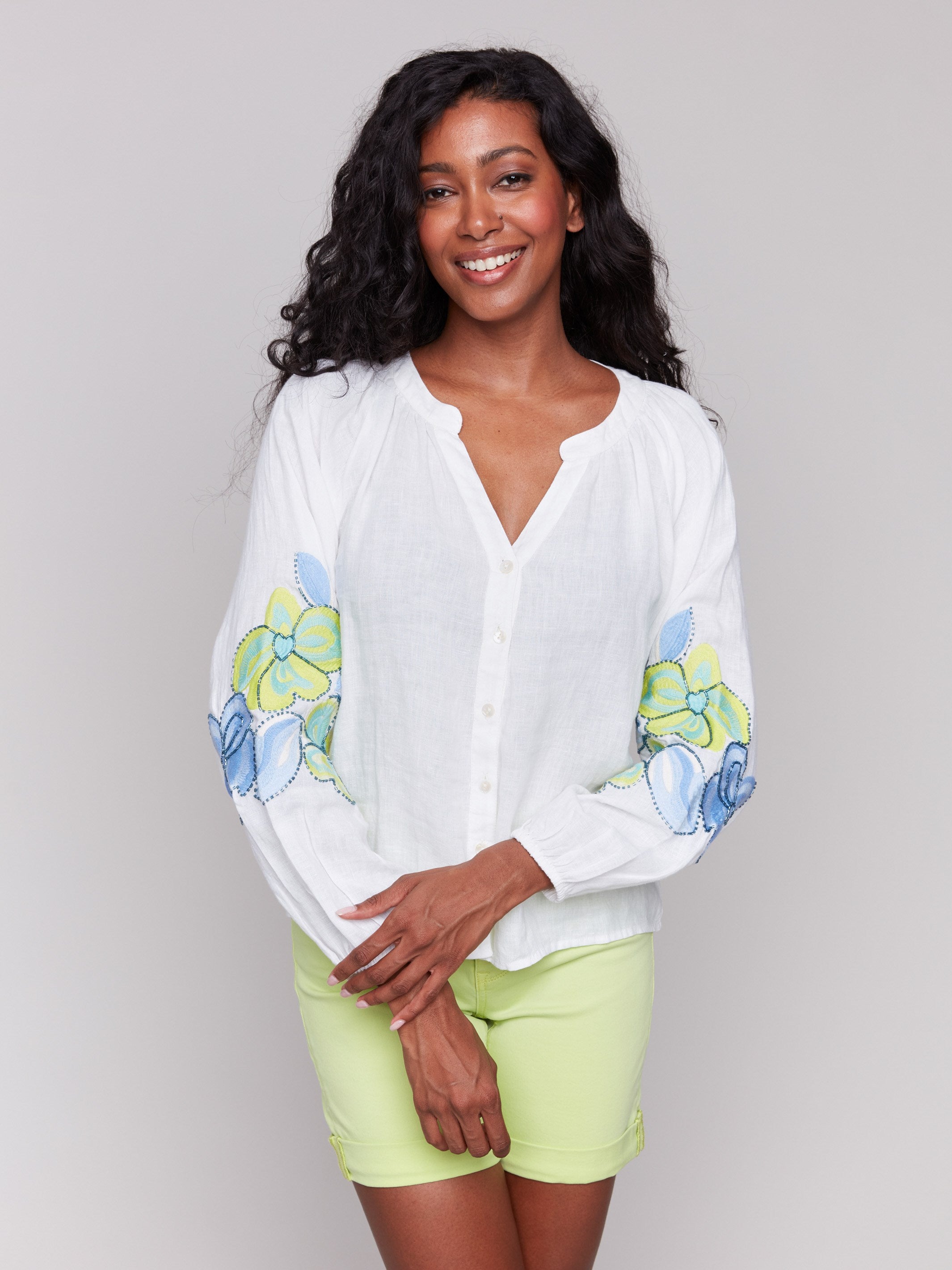 White linen blend blouse with V-neck and floral embroidery by Charlie B.