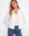 White denim jacket with frayed edges, featuring front button closure for a stylish look. Designed by Charlie B.