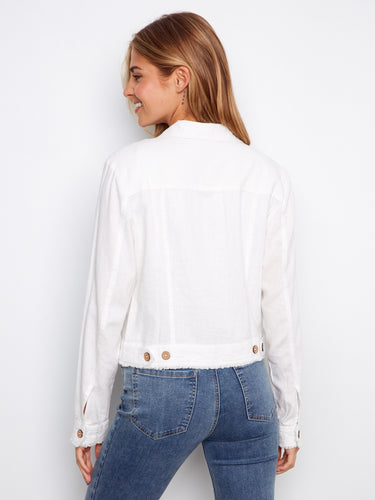 Versatile white jacket emphasizing its short length and comfortable fit in denim pairing. By Charlie B.