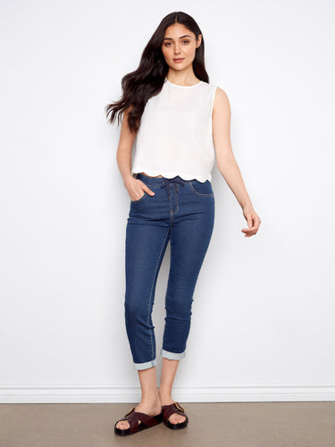 Chic white scallop hem top paired effortlessly with jeans, by Charlie B.
