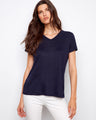 Navy linen blend T-shirt with a relaxed fit, paired stylishly with white pants for a casual look by Charlie B.