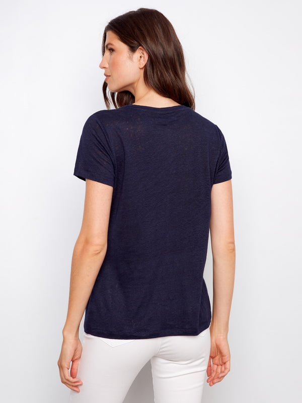 Linen blend navy T-shirt showcasing short sleeves, matched casually with white pants by Charlie B.
