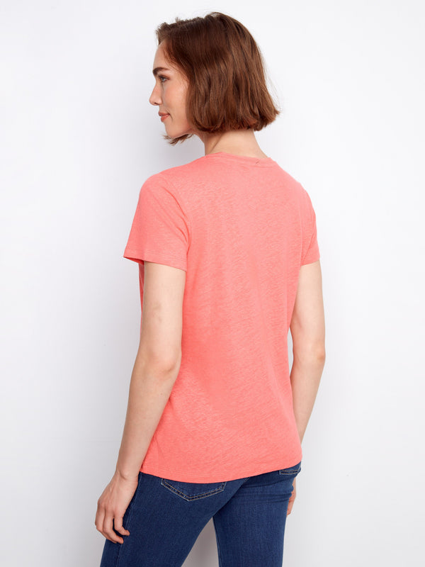 Stylish V-neck shirt in vibrant coral, designed for effortless fashion by Charlie B.