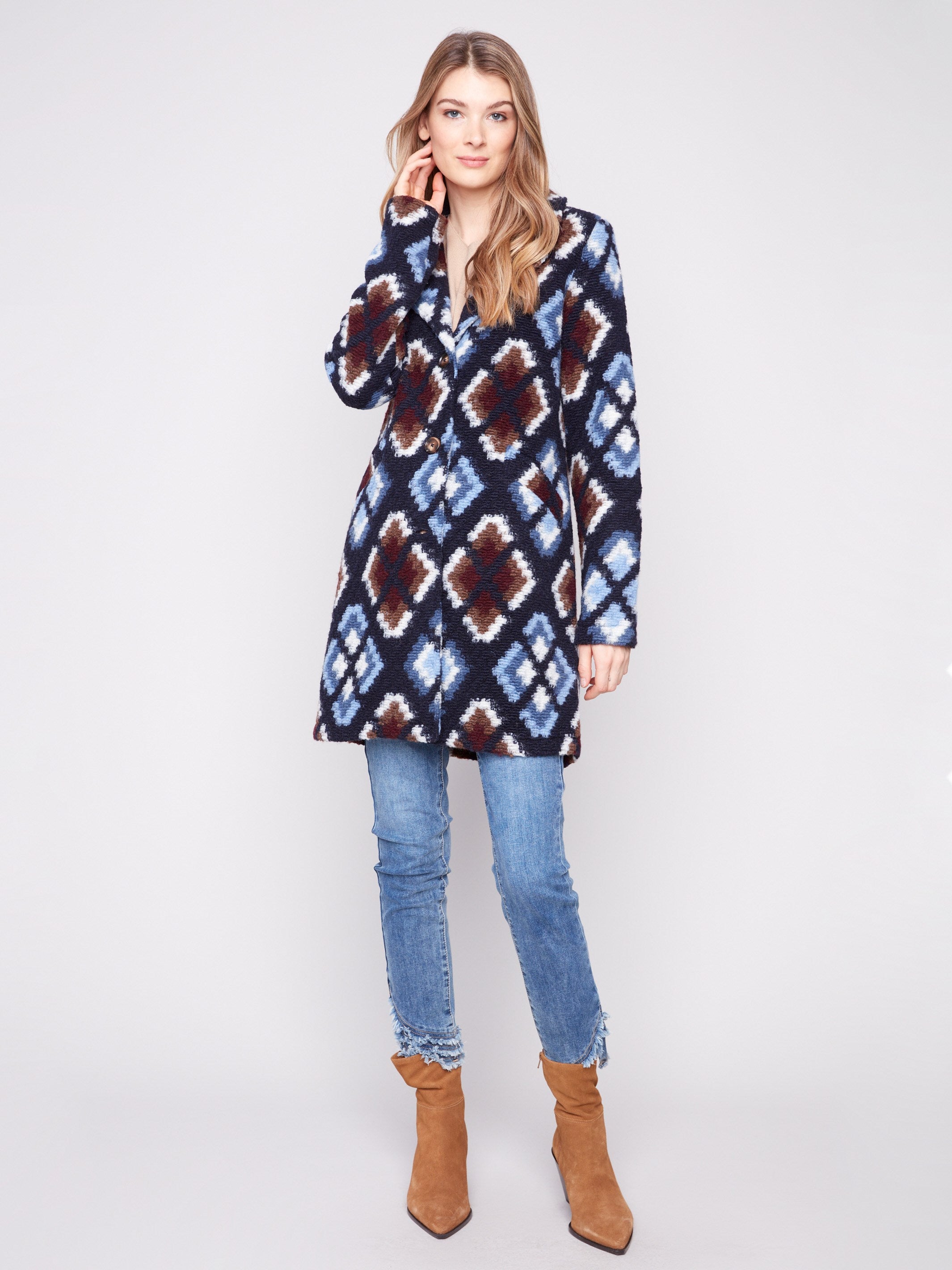 Crochet coat in twilight with tailored collar, showcasing a geometric pattern and welt pockets on front by Charlie B.