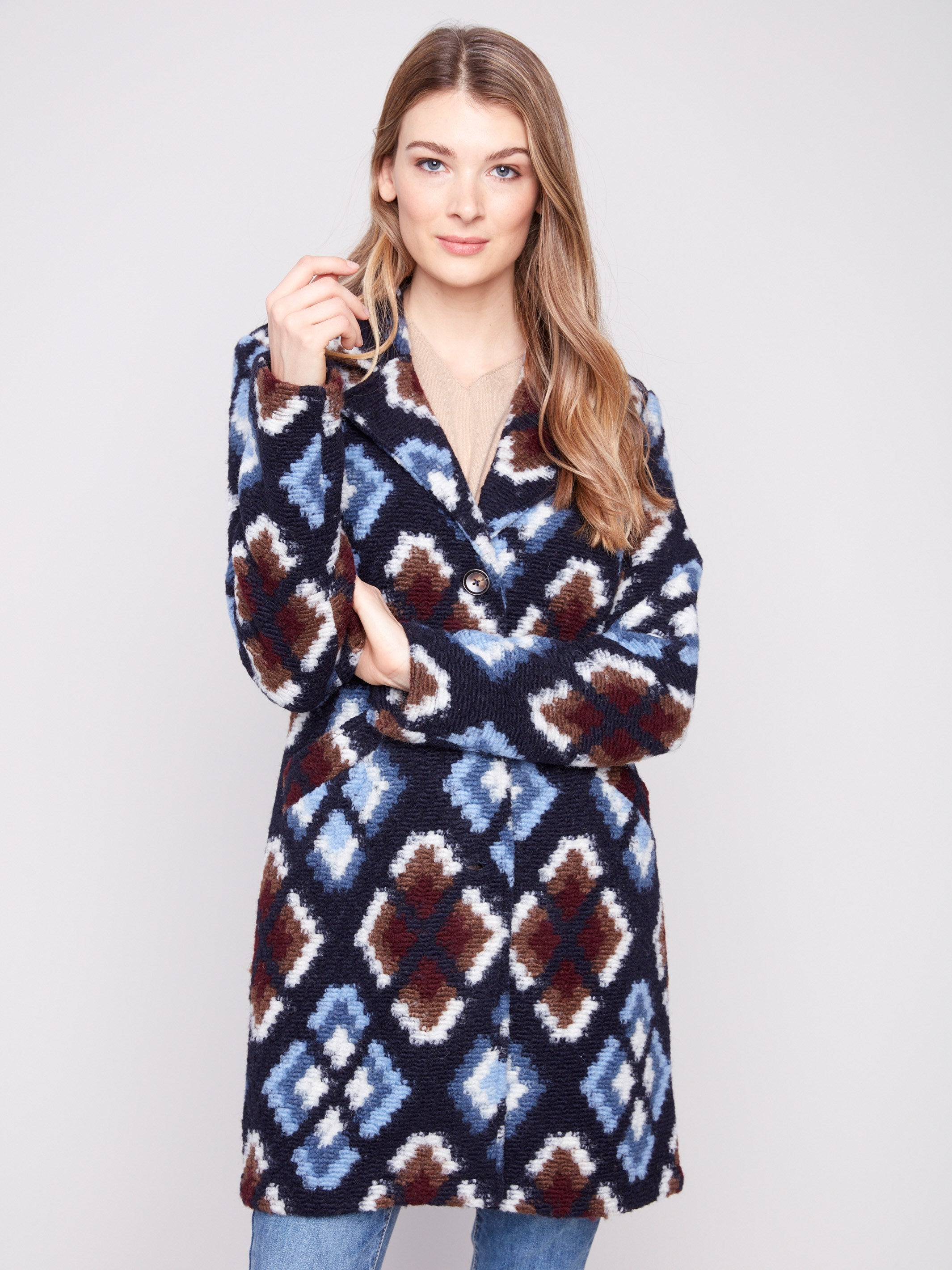 Stylish twilight crochet coat with welt pockets on front, adorned with a striking geometric pattern by Charlie B.