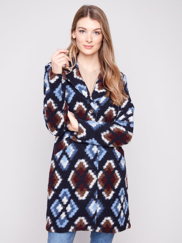 Stylish twilight crochet coat with welt pockets on front, adorned with a striking geometric pattern by Charlie B.