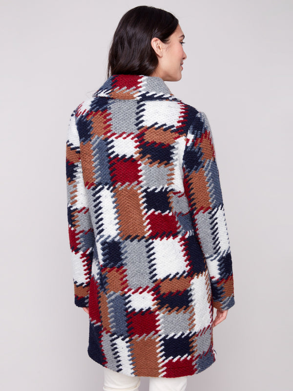 Chic crochet coat showcasing an eye-catching design with tailored details, crafted to elevate your fashion game by Charlie B.