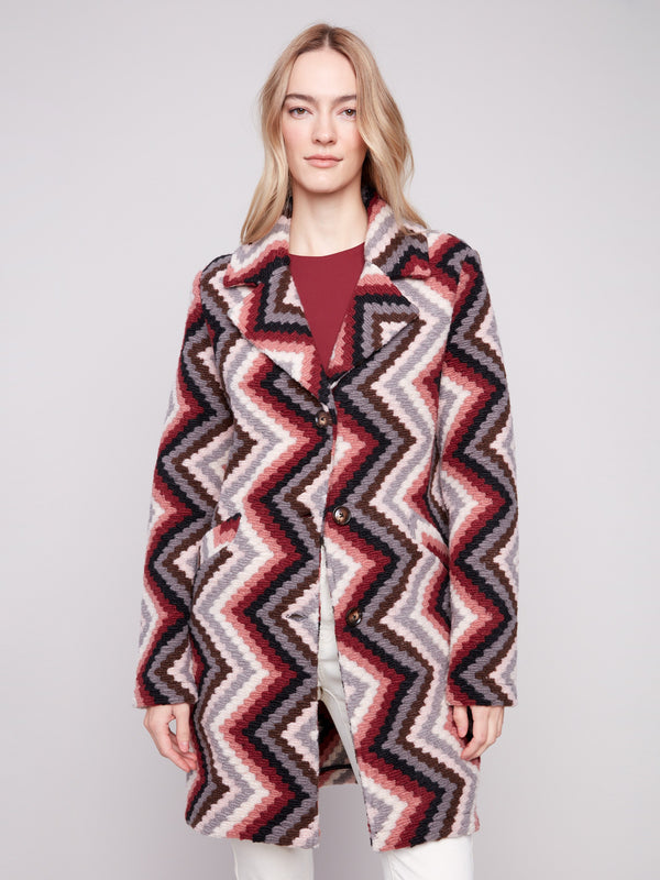 Crochet coat in primrose with a geometric pattern, featuring a tailored collar for a refined look by Charlie B.