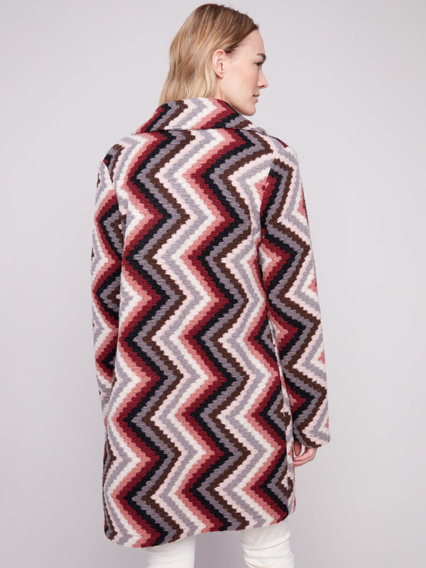 Geometric patterned crochet coat in primrose, highlighted by its classic button closure style by Charlie B.