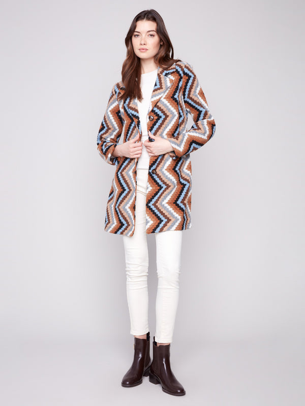 Sepia crochet coat with welt pockets and geometric design, perfect for a stylish look by Charlie B.