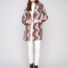 Sepia crochet coat with welt pockets and geometric design, perfect for a stylish look by Charlie B.