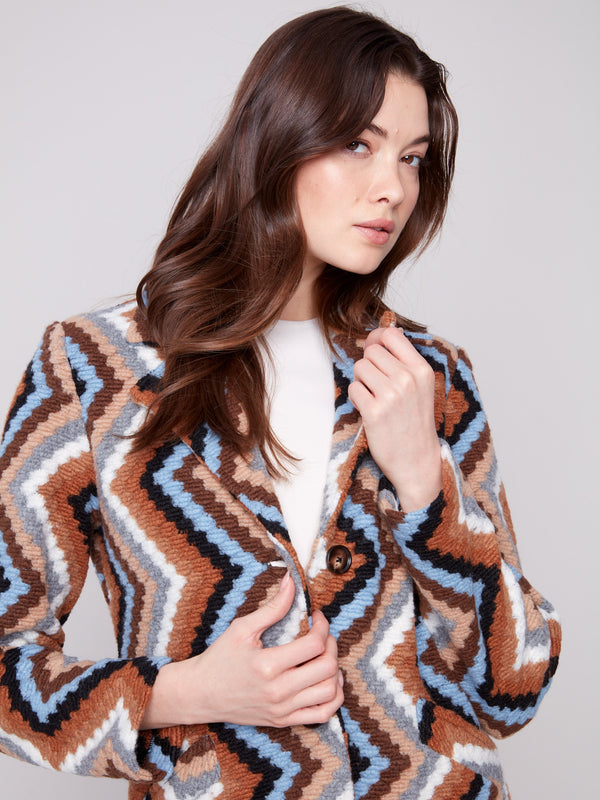 Welt pockets enhance the functionality of this sepia geometric patterned crochet coat by Charlie B.