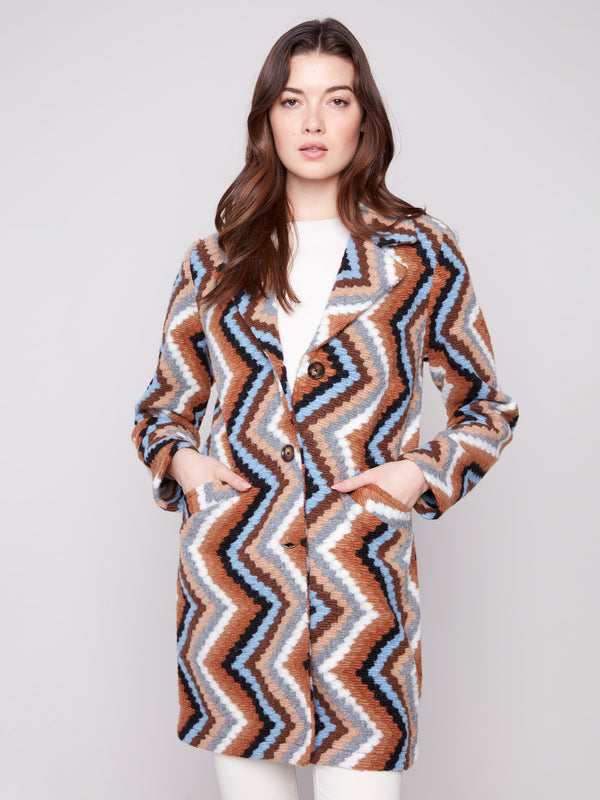 Button closure complements the tailored collar on this sepia crochet coat with geometric patterning by Charlie B.