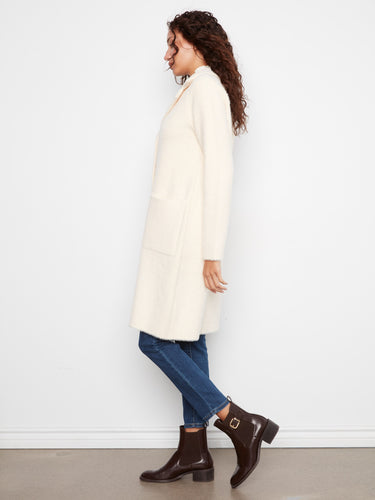 Stylish cream coat featuring practical patch pockets for added convenience by Charlie B.