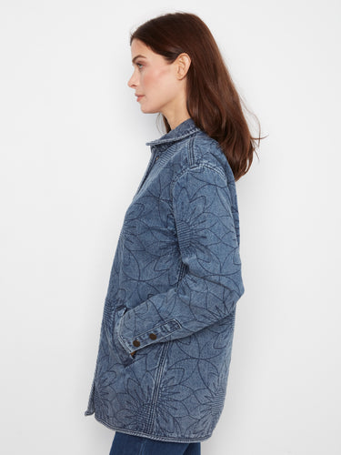 Medium blue denim jacket showcasing welt pockets and a trendy floral design for added flair, by Charlie B.