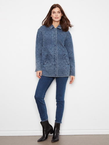 Quilted medium blue denim jacket featuring snap button closure and elegant floral patterns throughout. By Charlie B.