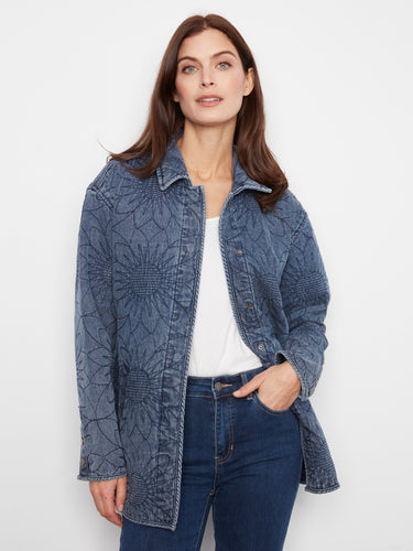 Floral designed quilted denim jacket in medium blue with functional welt pockets for everyday use. By Charlie B.
