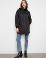 Quilted black coat featuring a removable hood, perfect for versatile styling and comfort. By Charlie B.