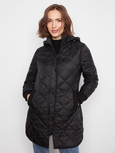 Elegant black coat with welt pockets, offering both style and practicality. By Charlie B.