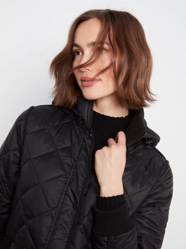 Sophisticated black coat with front zip closure and snap buttons for secure wear. By Charlie B.