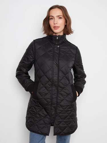Black quilted coat designed with a sleek silhouette, emphasizing modern fashion trends. By Charlie B.
