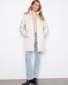 Quilted coat featuring a removable hood for versatile styling, perfect for any season. Designed with attention to detail by Charlie B.