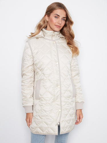 Elegant quilted coat with practical welt pockets, combining style and functionality effortlessly. A timeless piece by Charlie B.
