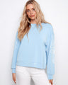 Light blue scuba top featuring a relaxed fit and soutache detail on sleeves by Charlie B.