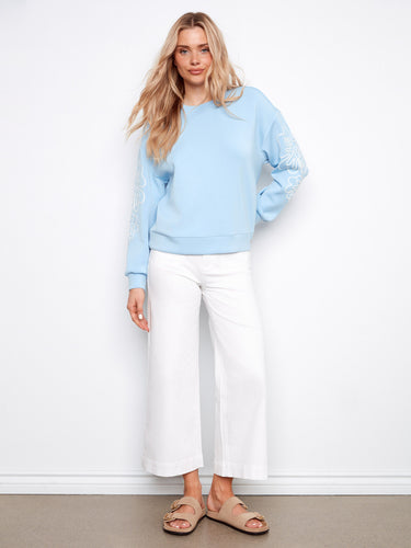 Scuba top in light blue with drop shoulders and intricate sleeve detailing by Charlie B.