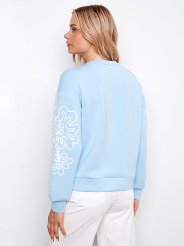 Elegant light blue top with relaxed fit, highlighting the unique soutache design by Charlie B.