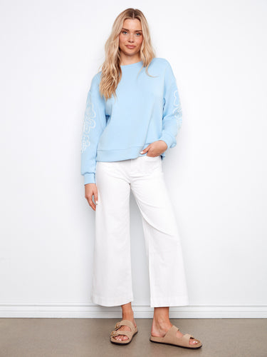 Chic blue scuba top with crew neckline and stylish drop shoulders by Charlie B.