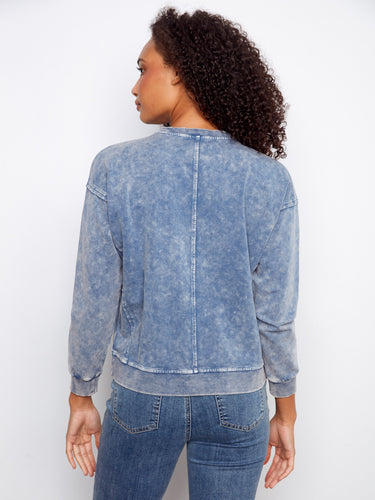 Comfortable blue sweatshirt with drop shoulders and ribbed edges, offering both style and ease of movement. By Charlie B.