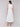 Sophisticated white dress showcasing an elastic waist design by Charlie B.