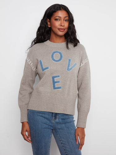 Sweater featuring a mock neck with a stylish denim LOVE appliqué, perfect for casual outings. Designed by Charlie B.