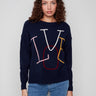 Navy sweater featuring colorful 'LOVE' embroidery in a playful design, paired with ribbed cuffs for added style by Charlie B.