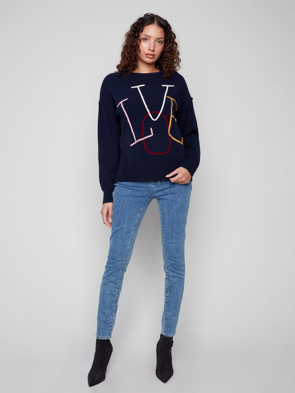Stylish navy sweater with drop shoulder design and vibrant 'LOVE' letters. Perfect blend of comfort and chic by Charlie B.