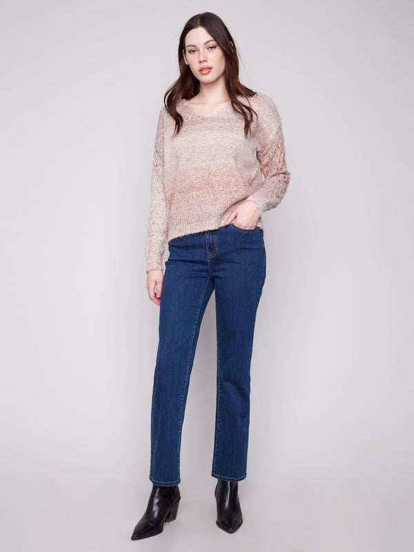 Chic latte sweater with metallic threads adding subtle shimmer to the space dye pattern, crafted by Charlie B.