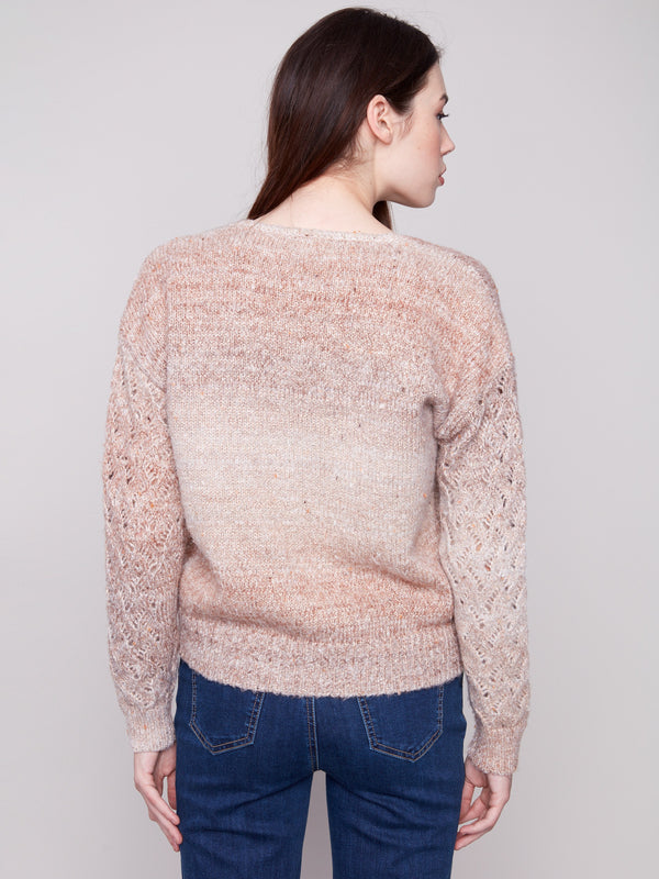 Elegant latte sweater showcasing intricate open knit sleeves with beautiful detailing by Charlie B.