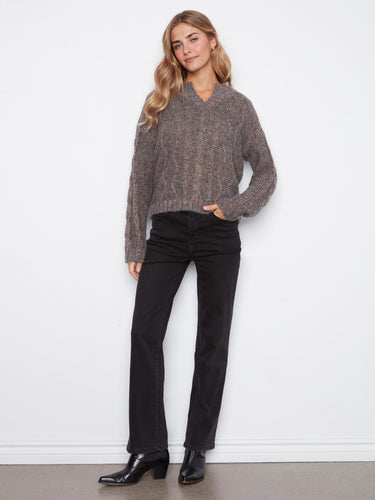 Metallic flecked yarn in this grey cable knit sweater adds shimmer to the drop shoulder design by Charlie B.