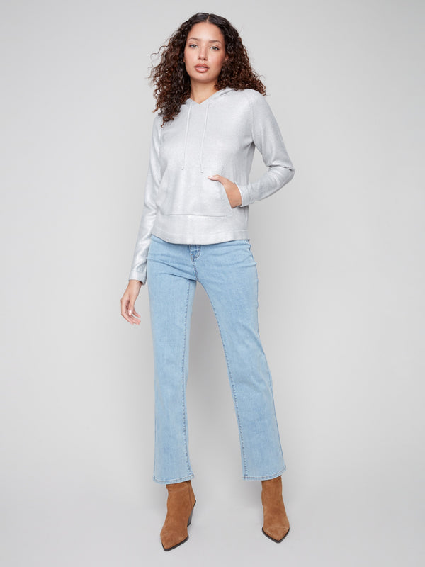 Featuring a convenient front pocket, this silver metallic knit hoodie is both chic and practical by Charlie B.